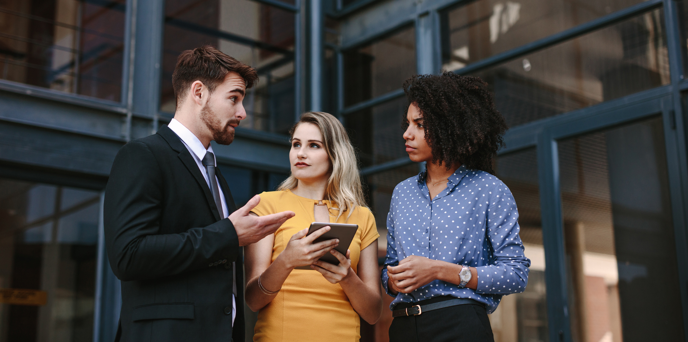 Man communicating with two women